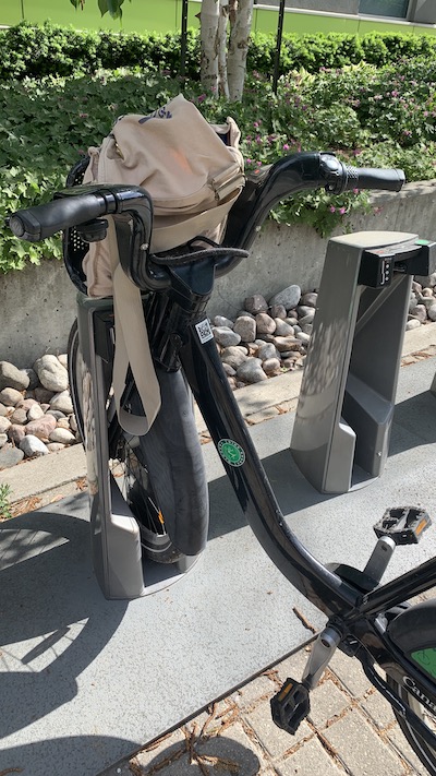 A city bike with a canvas bag in the basket.